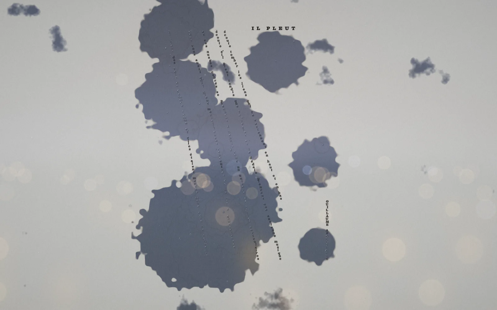 The rain soaks the page: dark wet blots spread across it
